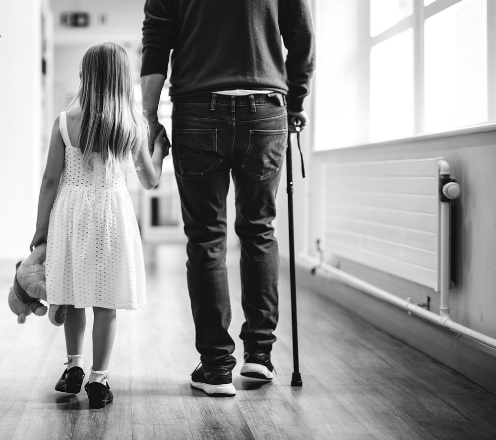 Daughter walking with her disabled father