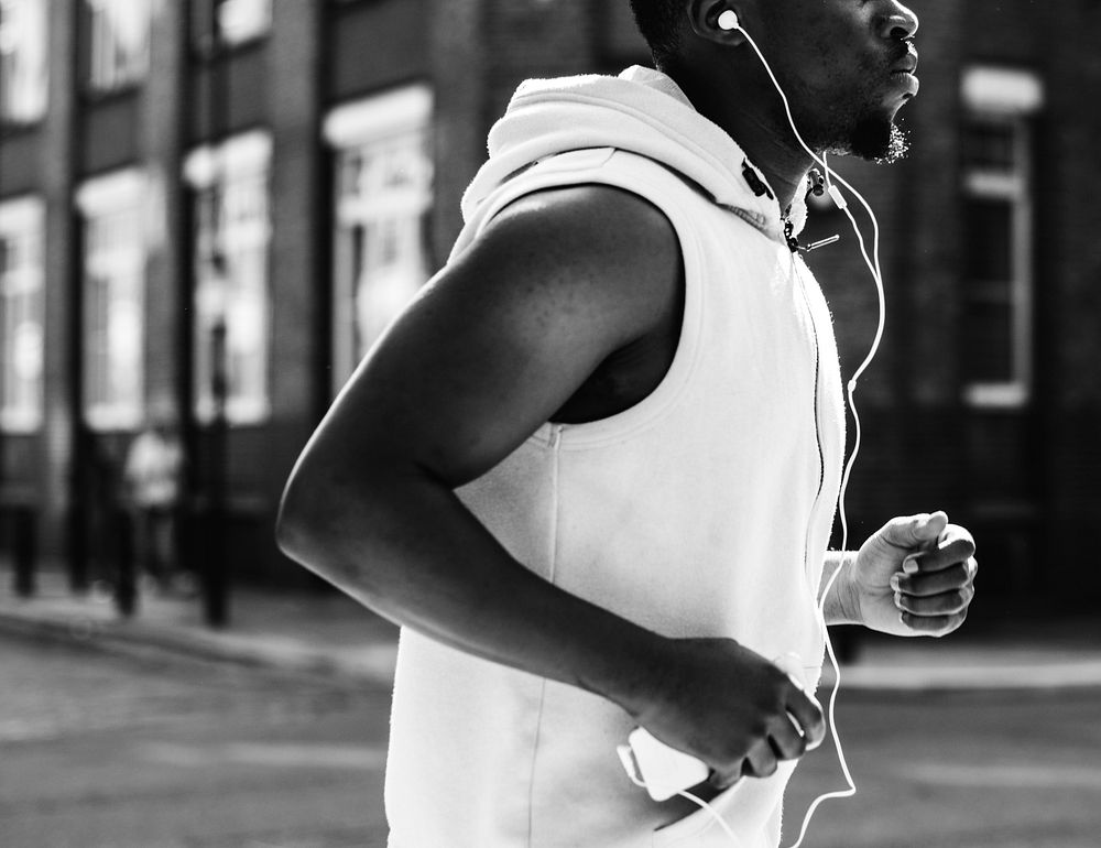 Athletic man running with earphones