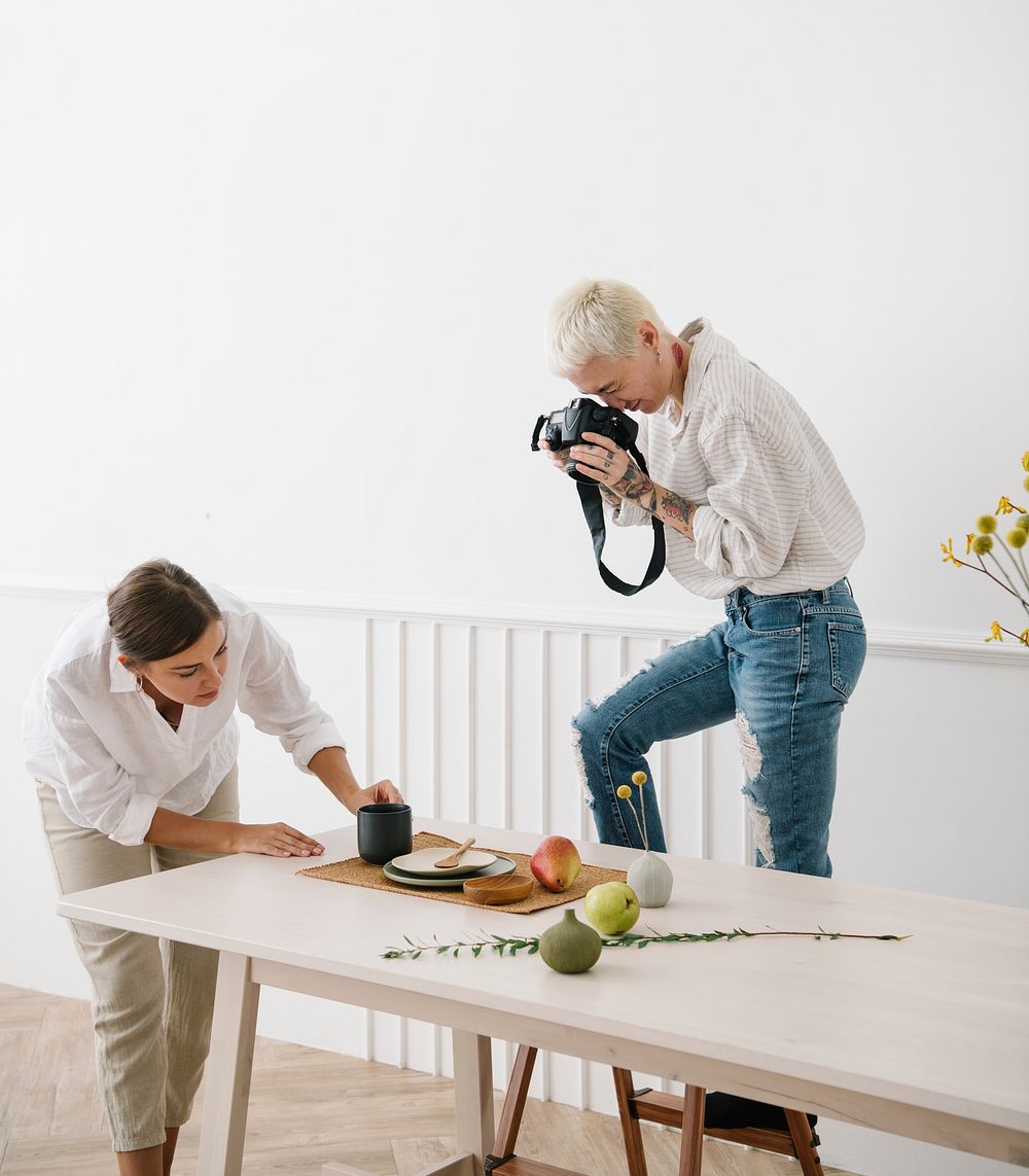 Blogger photographing the plate decor on the dining table