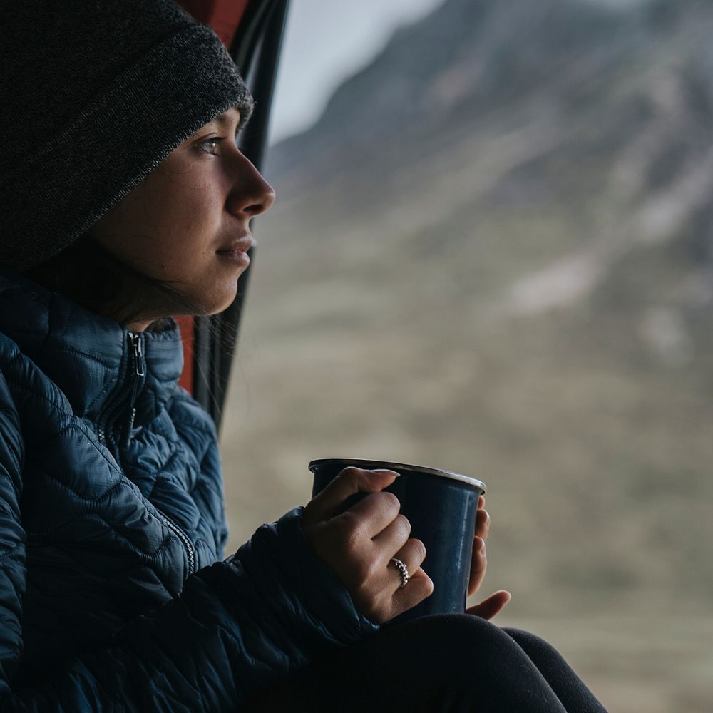 Woman in a camper with a cup of coffee