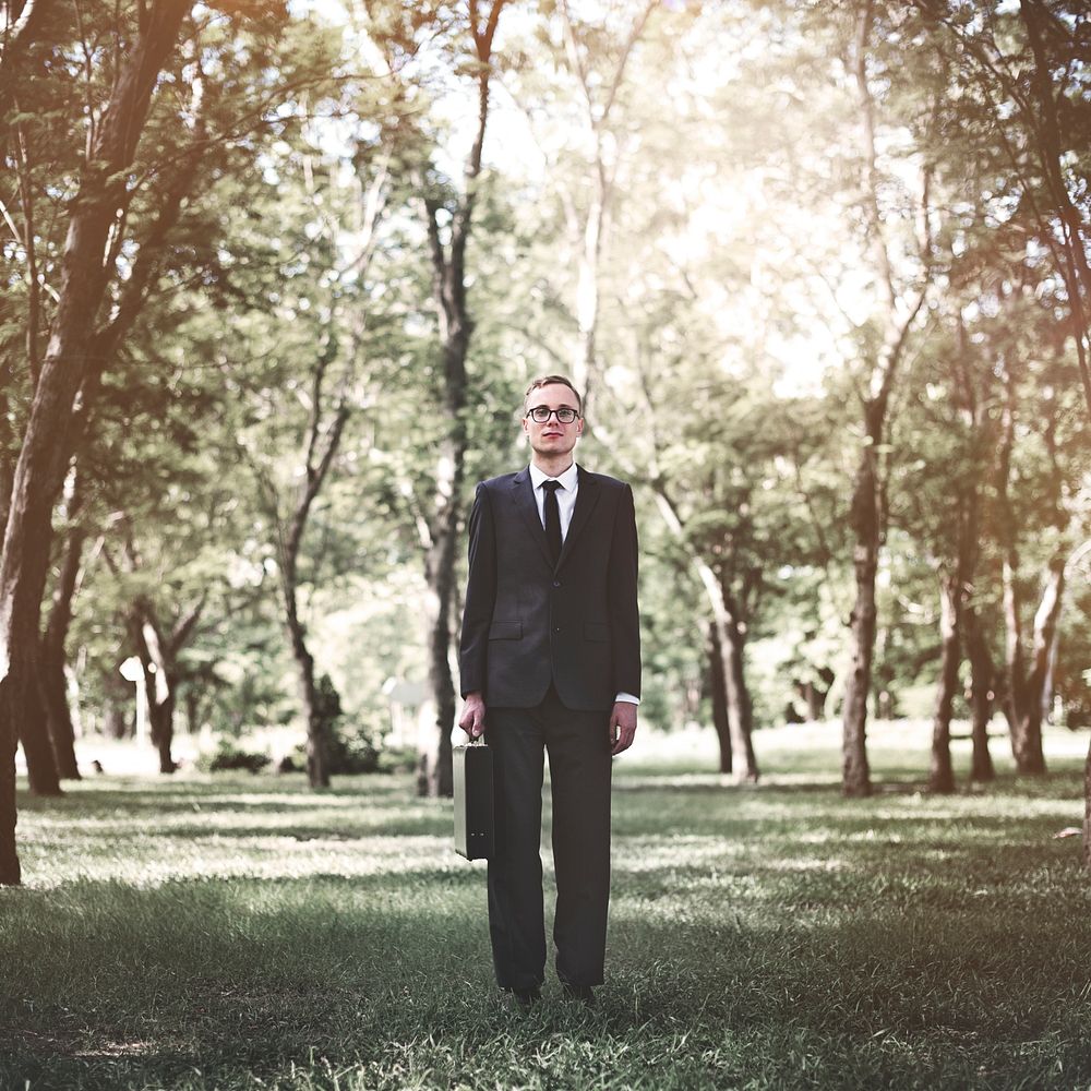 Business man standing alone in nature