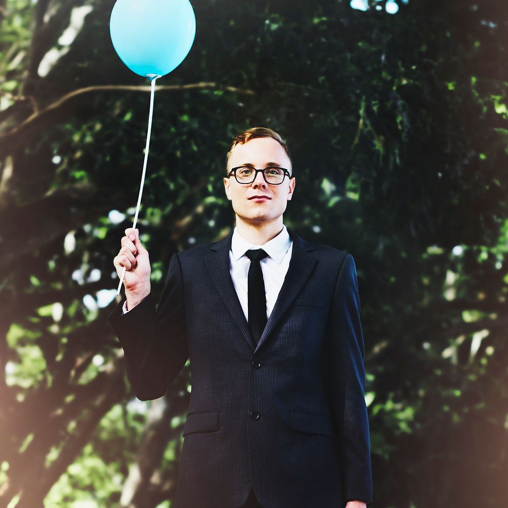 Businessman holding balloon