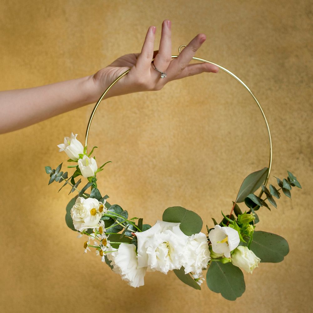 Girl holding a leaf decorated round golden frame