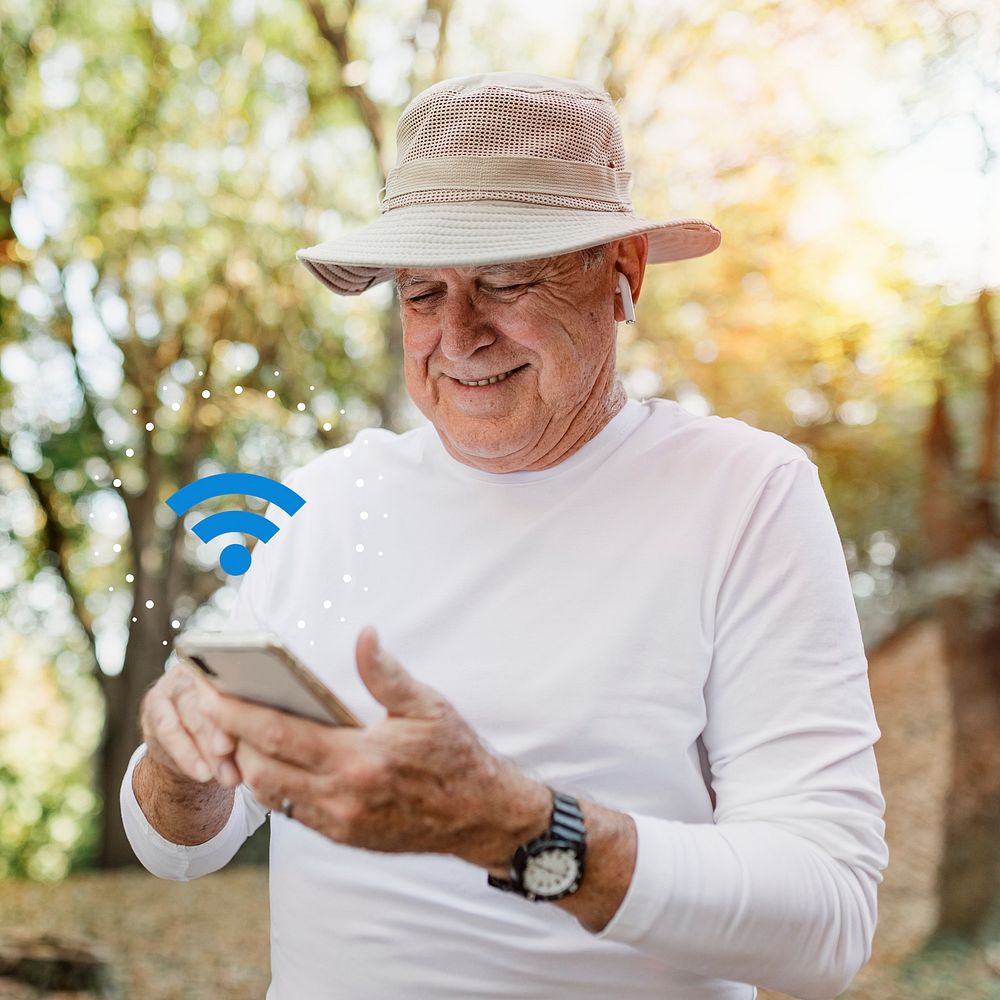 Modern grandpa psd enjoying his digital gadgets in nature
