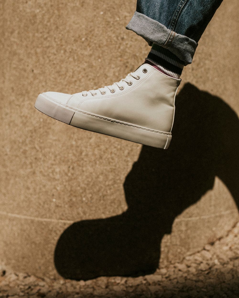 White high top sneakers side view on model