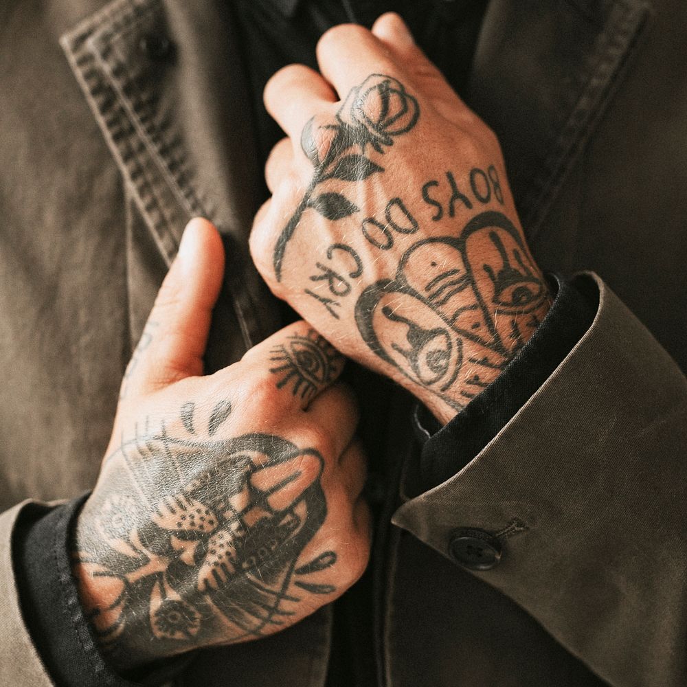 Man with tattooed hands holding his shirt. 2 OCTOBER 2020 - CHIPPENHAM, UK