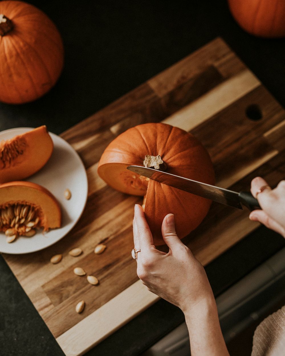 Woman slicing pumpkin for Thanksgiving dinner food photography