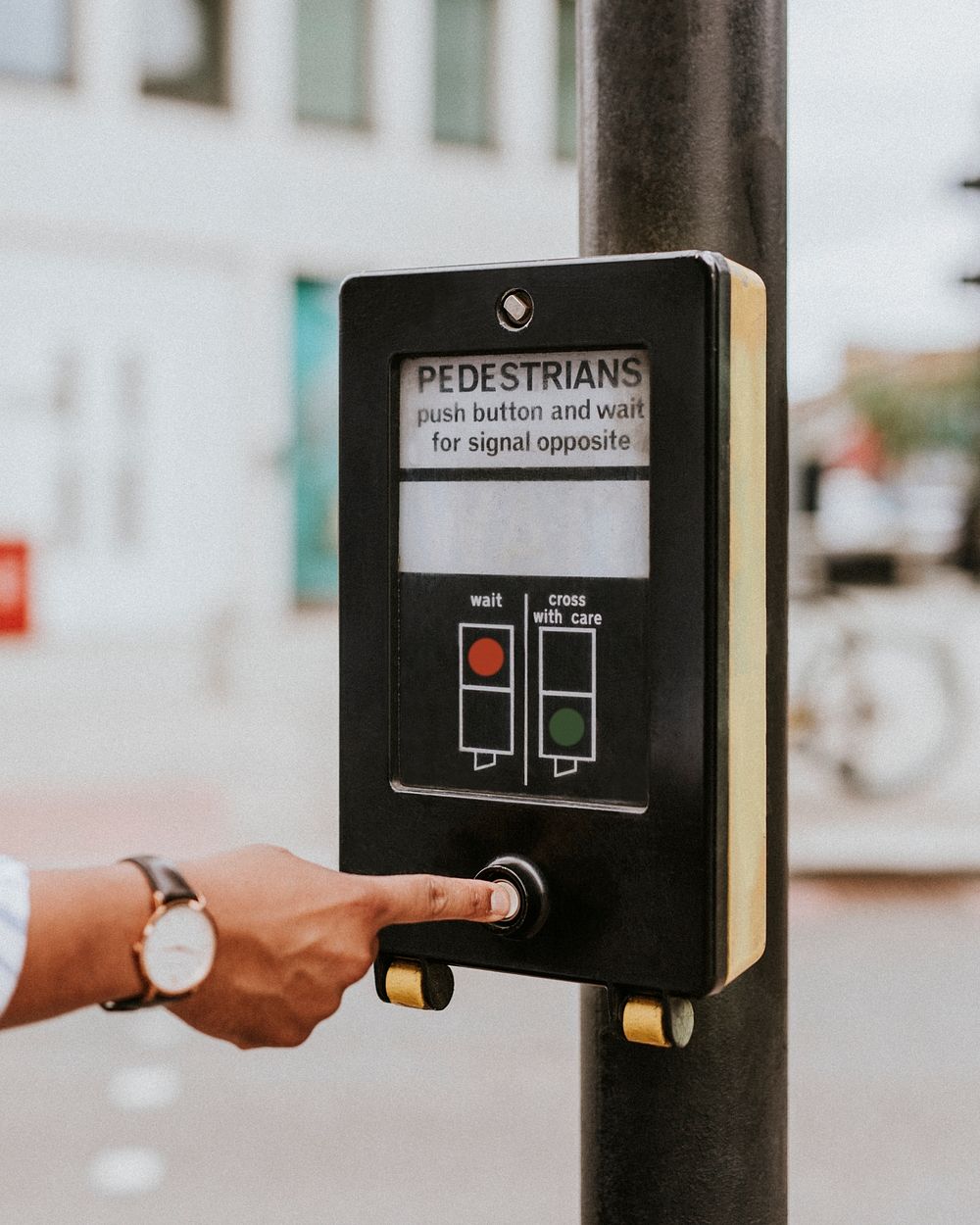 Person pressing a pedestrian cross push button 