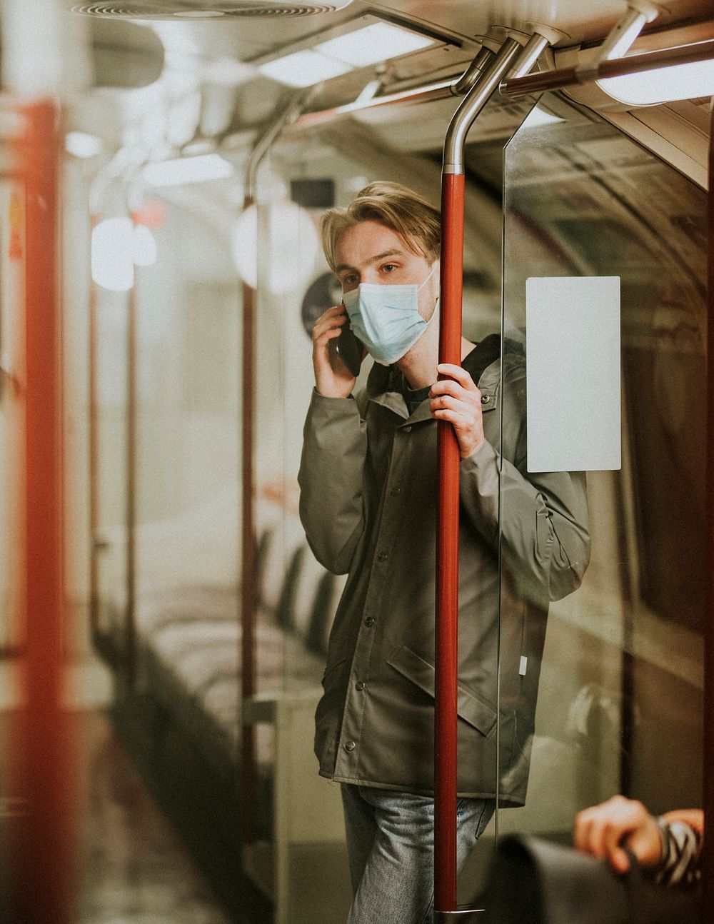 Man using a phone on a train in the new normal 