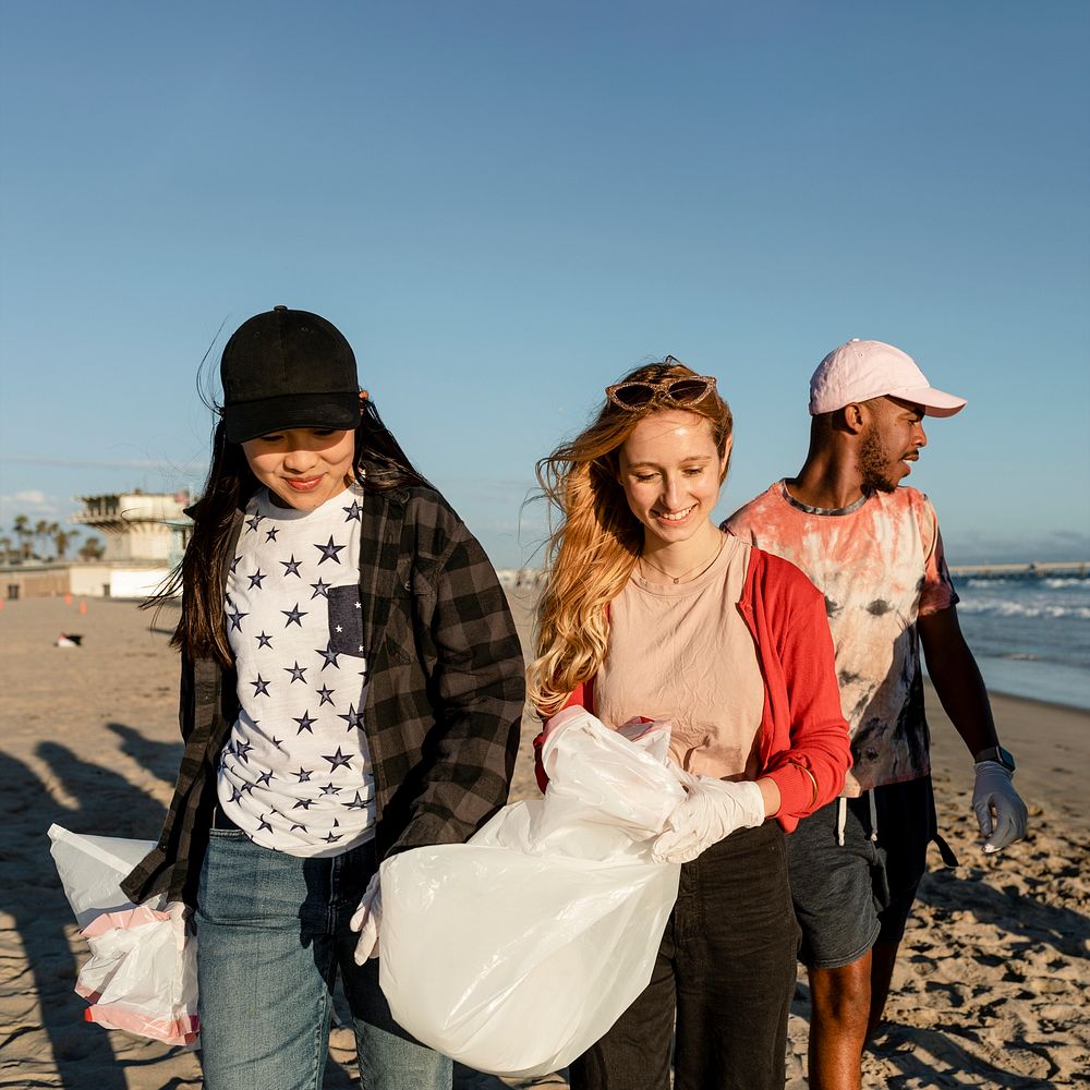 Trash pick up volunteering, group of teenagers at the beach