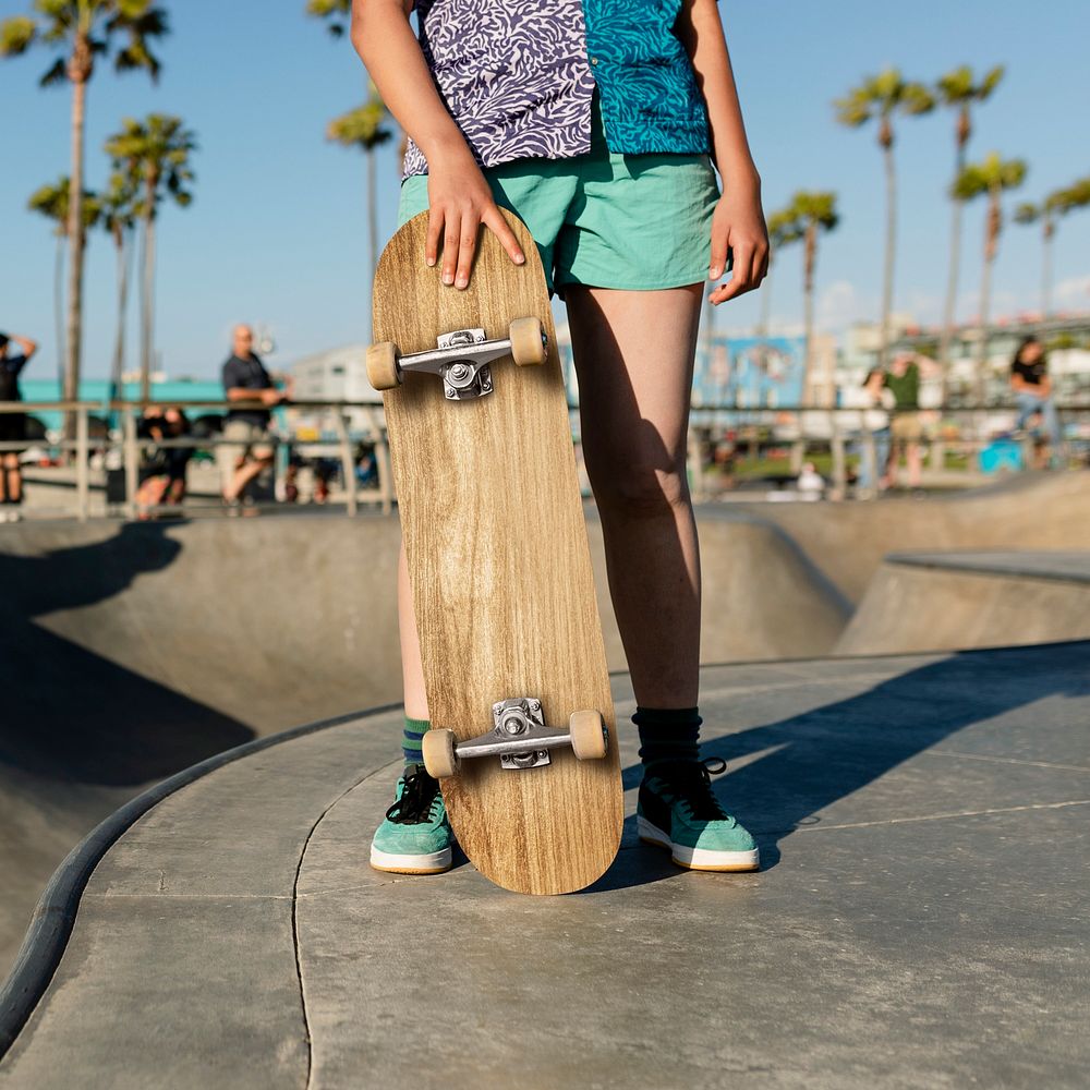 Teen girl with a skateboard, at a skatepark in Venice Beach, LA