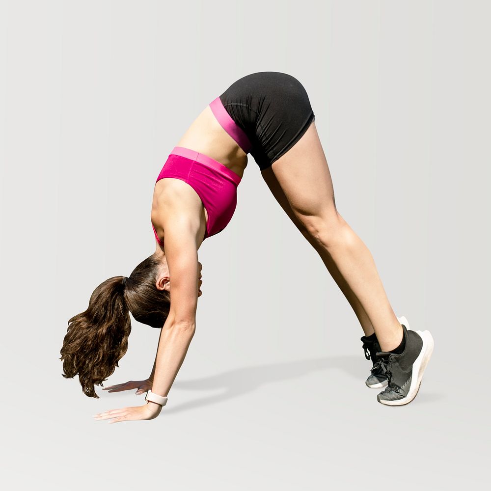 Woman athlete stretching by doing a downward dog psd 