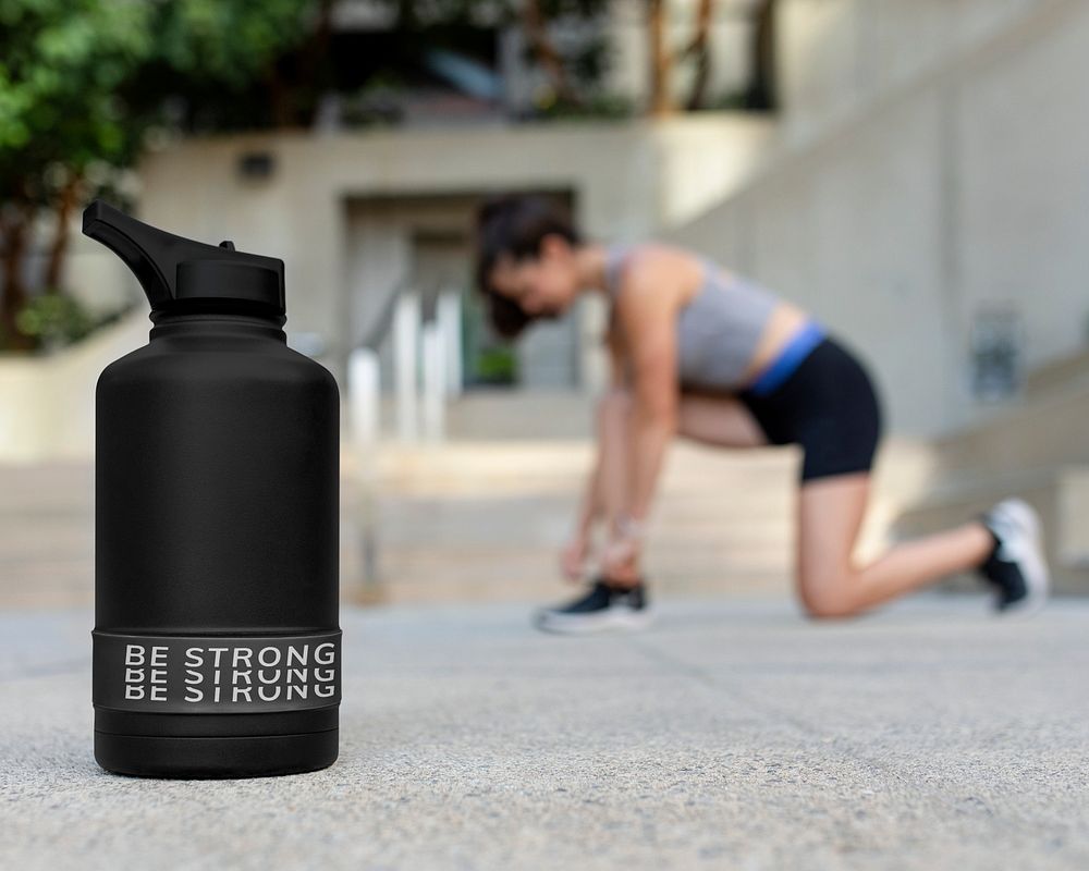Insulated water bottle mockup psd by a woman's tying her shoelaces 