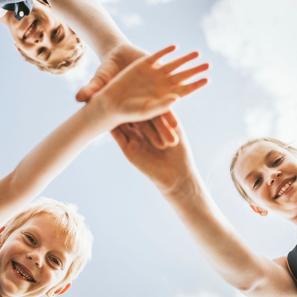 Kids stacking hands in the middle, family photo