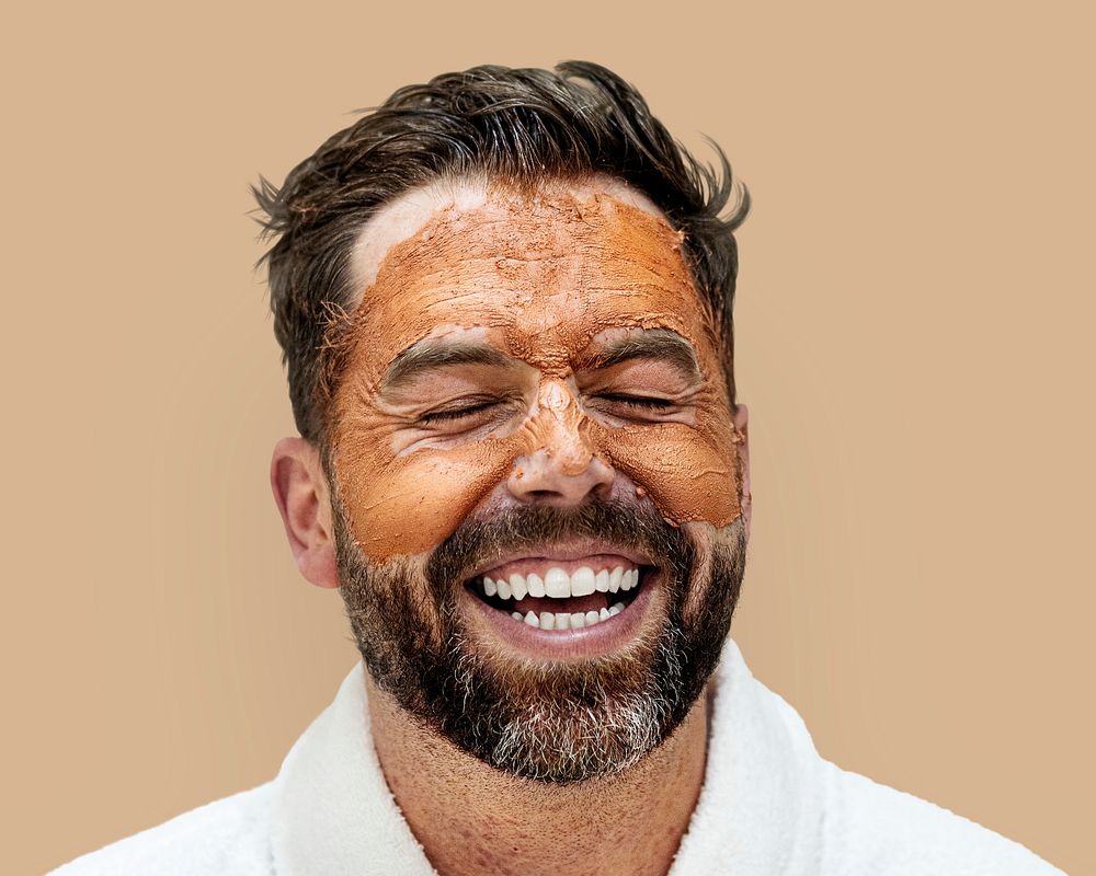 Man in beauty face mask isolated on background psd