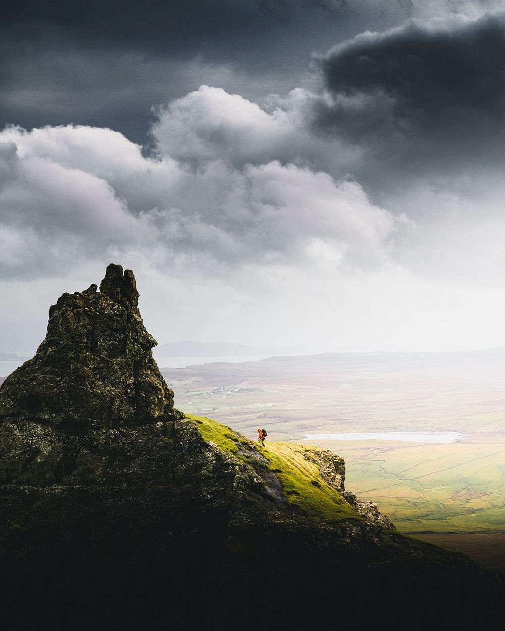 Man walking on the slope of Quiraing, Scotland