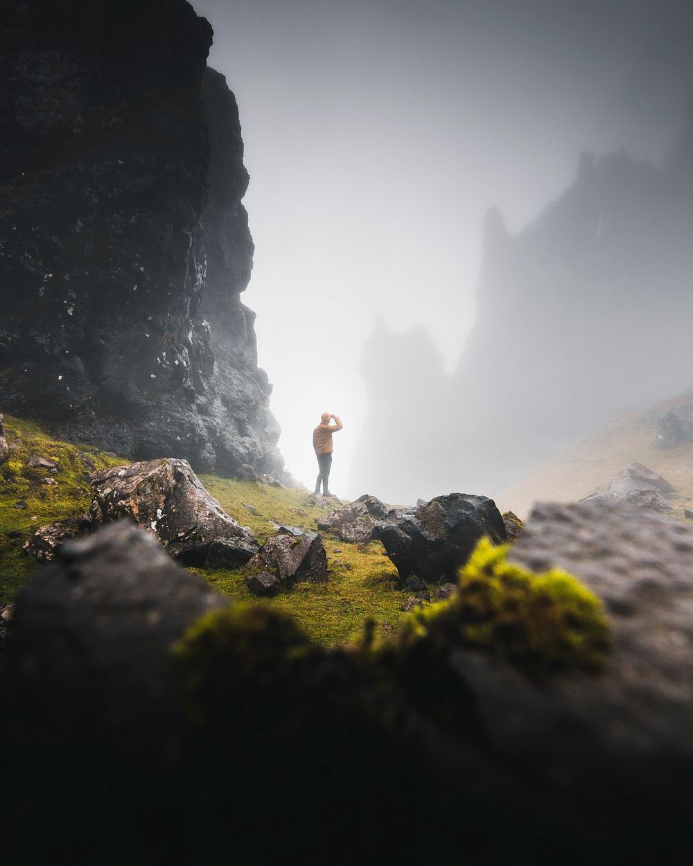 Man trekking in the misty Old Man of Storr, Scotland