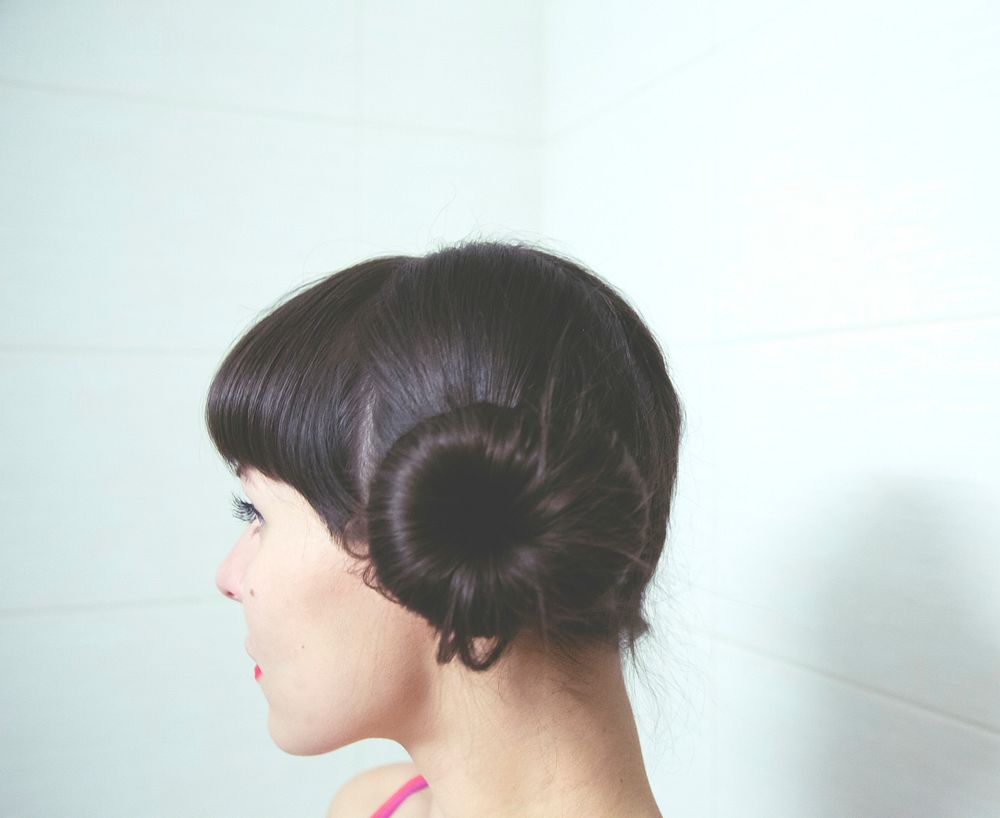 Profile of a woman with donut bun hairstyle