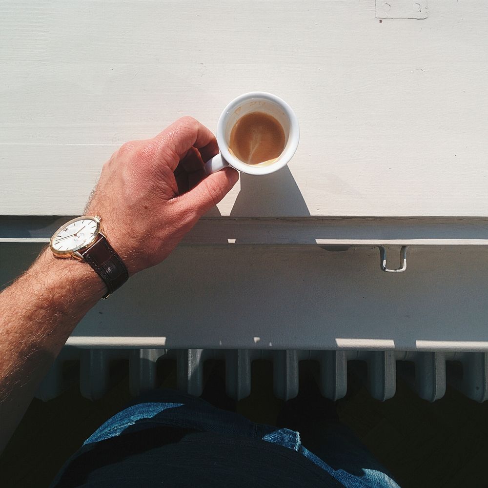 Man holding a cup of espresso