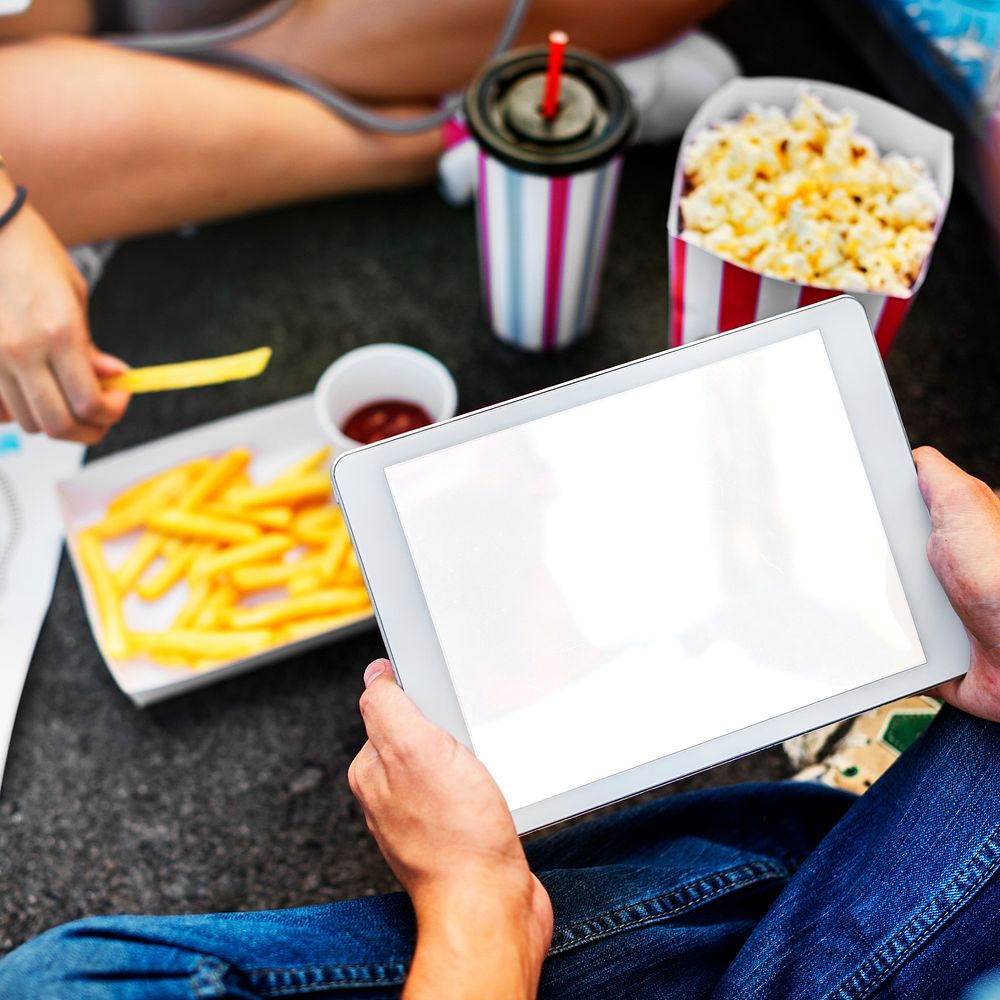 Junk food and a digital tablet with an empty screen