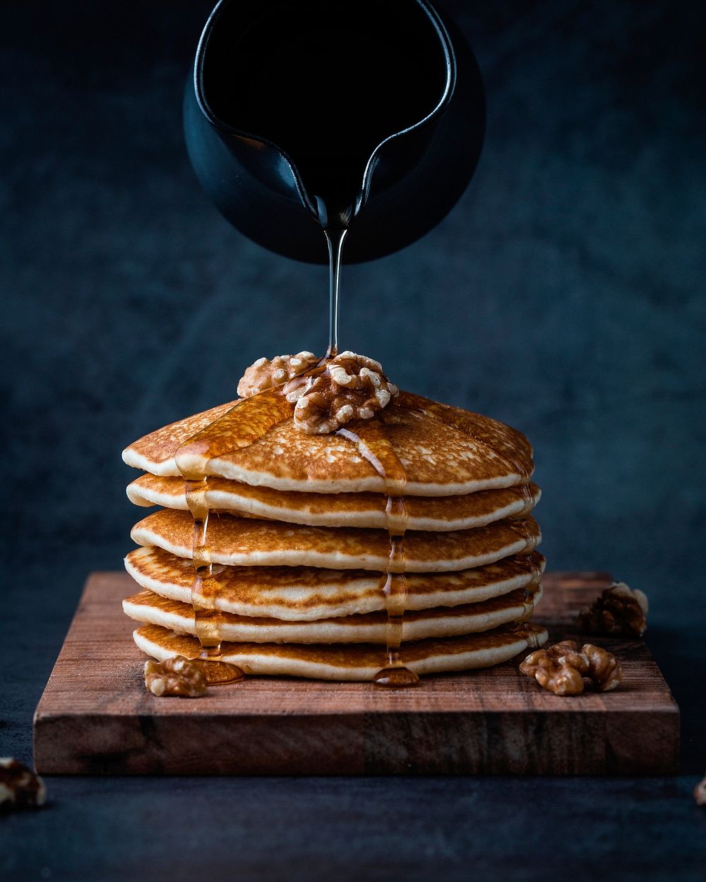 Free pouring honey on pancakes with walnuts image, public domain food CC0 photo.
