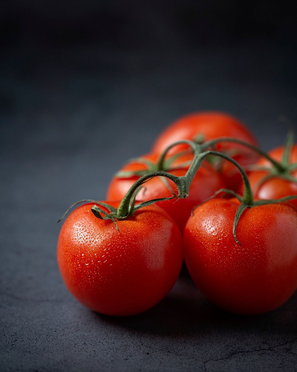 Cherry tomatoes on a stem.