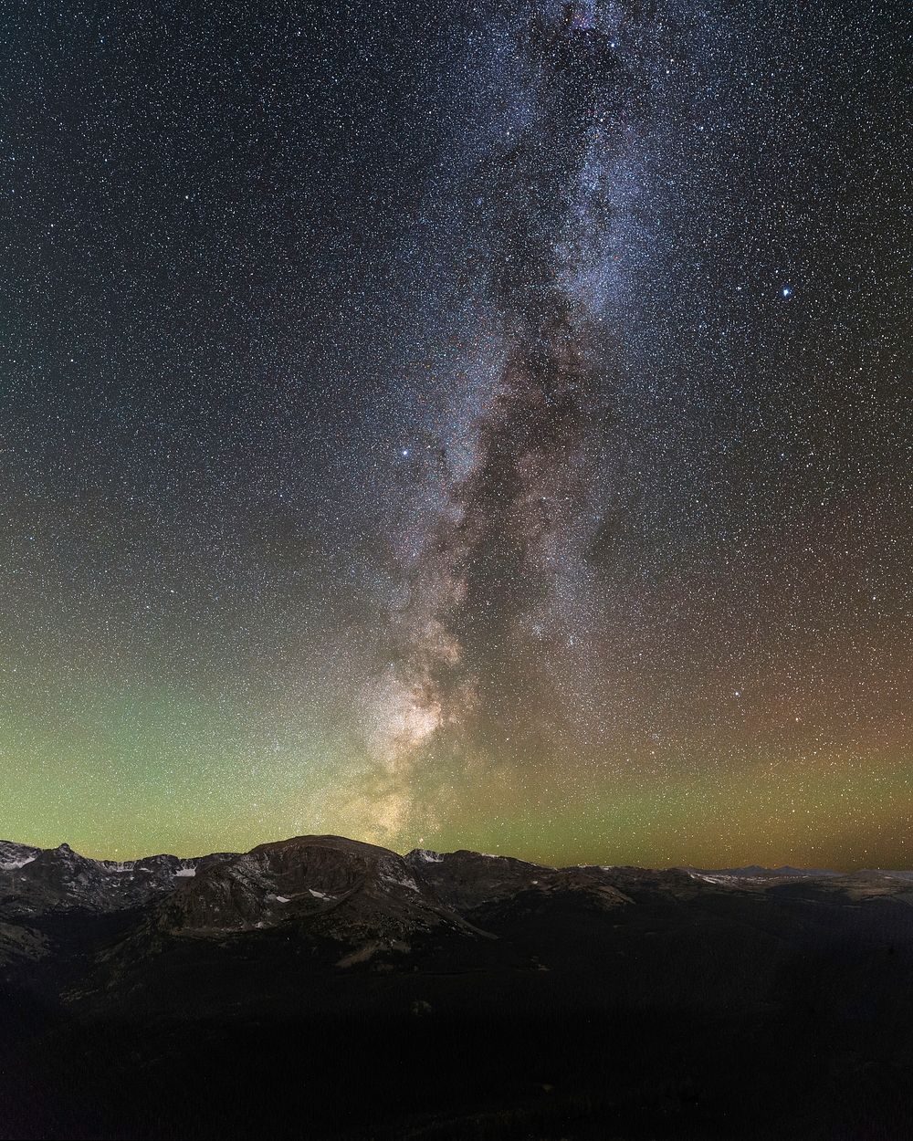 The Milky Way spans the extent of the night sky over Rocky Mountain National Park at Forest Canyon Overlook along Trail…