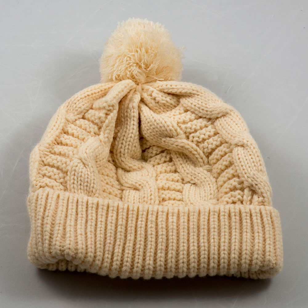 Cream knit hat with pom pom. Free public domain CC0 image.