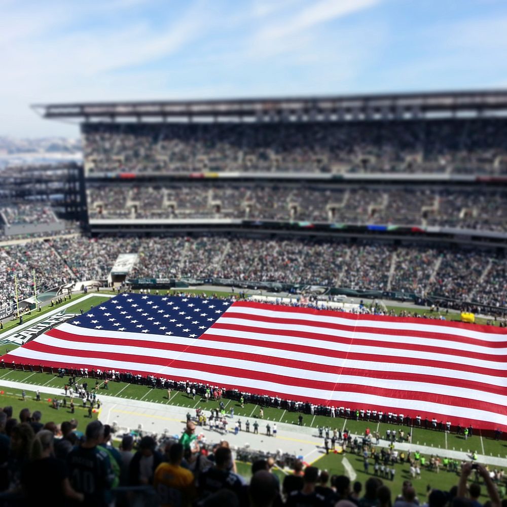 US flag in football stadium with tilt-shift effect. Original public domain image from Flickr
