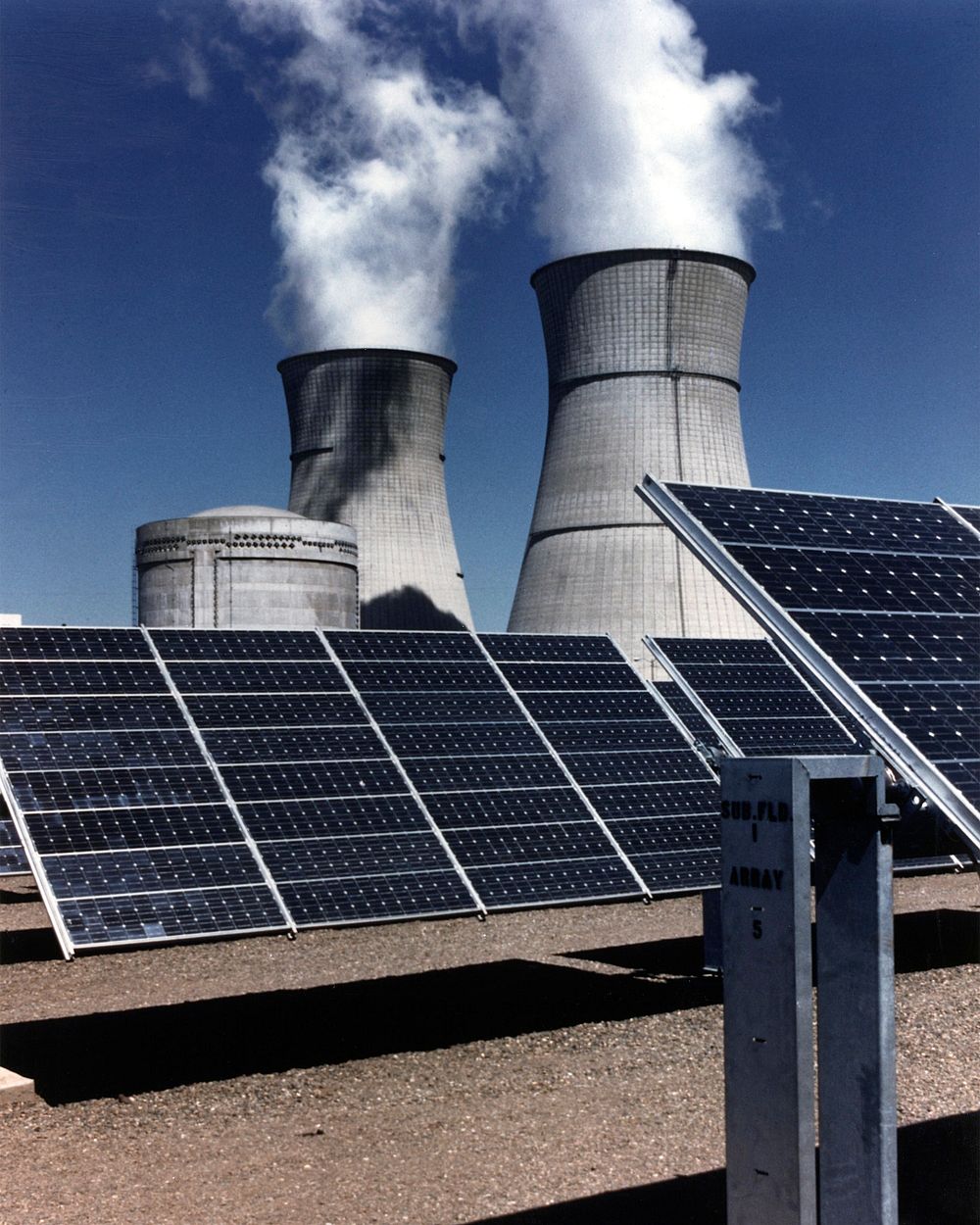 View of smudpv1 photovoltaic panels, with the twin cooling towers of the rancho seco nuclear plant in background.