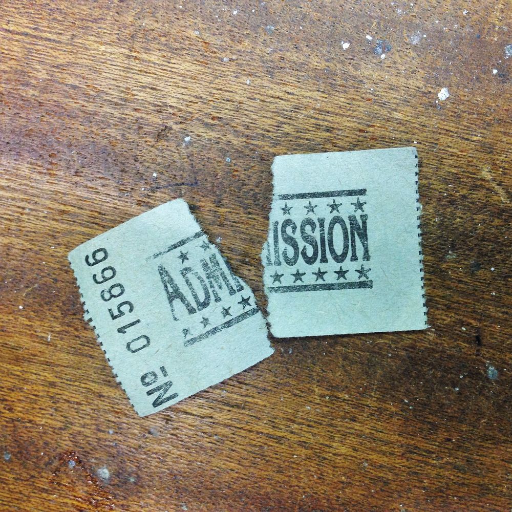 Ripped old admission stamp. Free public domain CC0 photo.