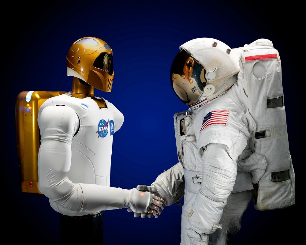 NASA Robonaut 2 shaking hands with astronaut, USA, Date unknown. 