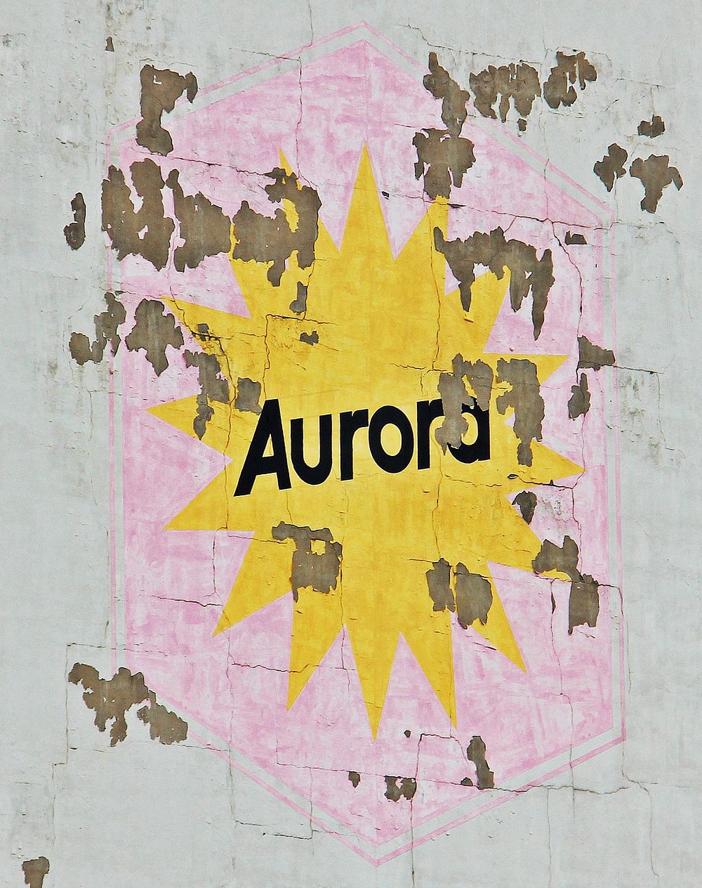 Aurora word on weathered wall. Free public domain CC0 photo.
