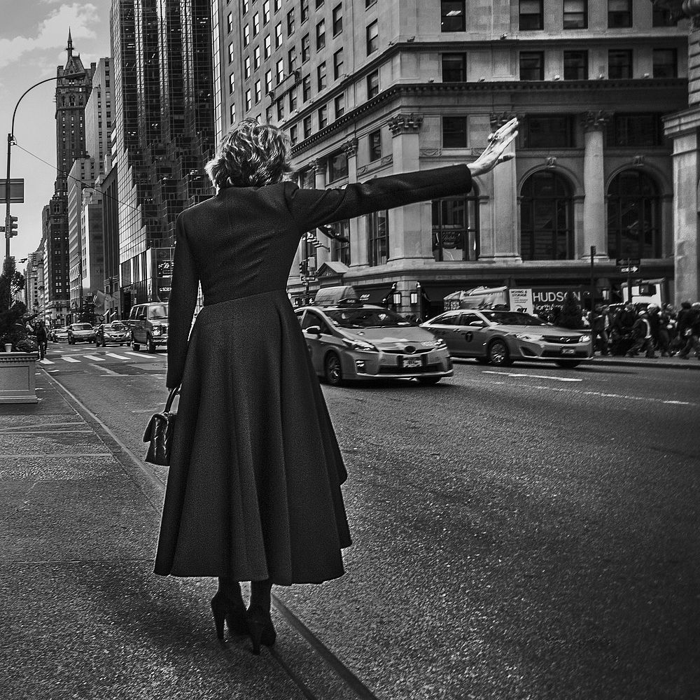 Woman waving for a taxi. Free public domain CC0 photo.