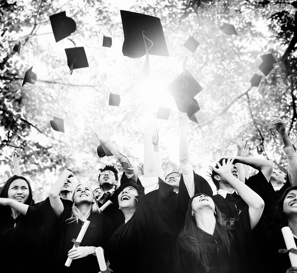 Diverse graduates throwing hats in the air