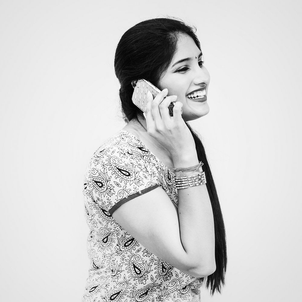 A young Indian woman talking on the phone