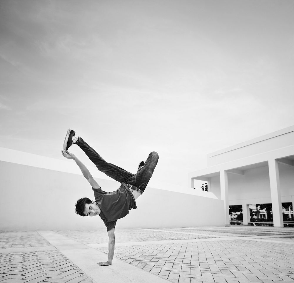Young man break dancing at a rooftop