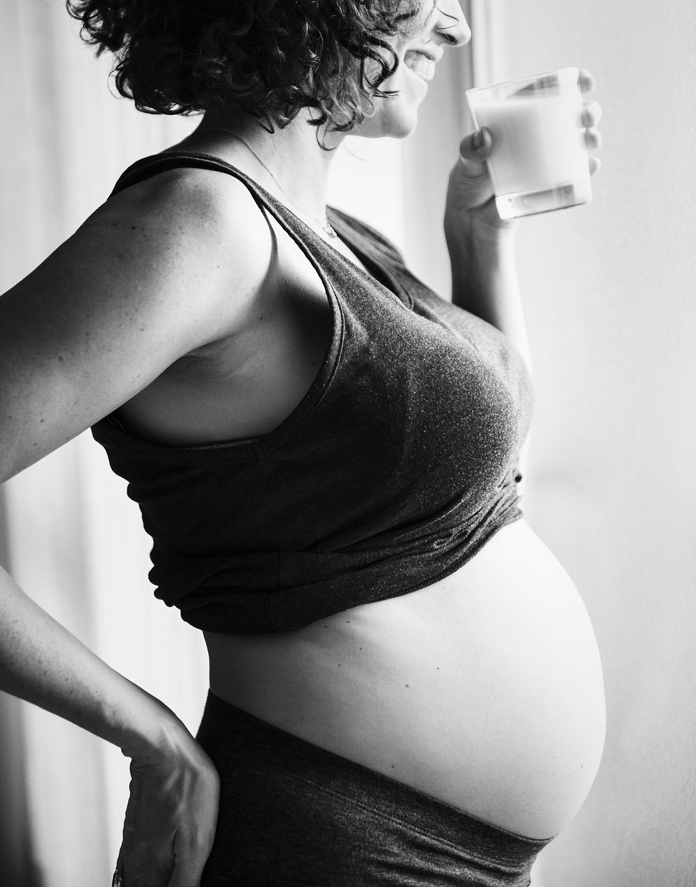 Pregnant woman drinking some milk