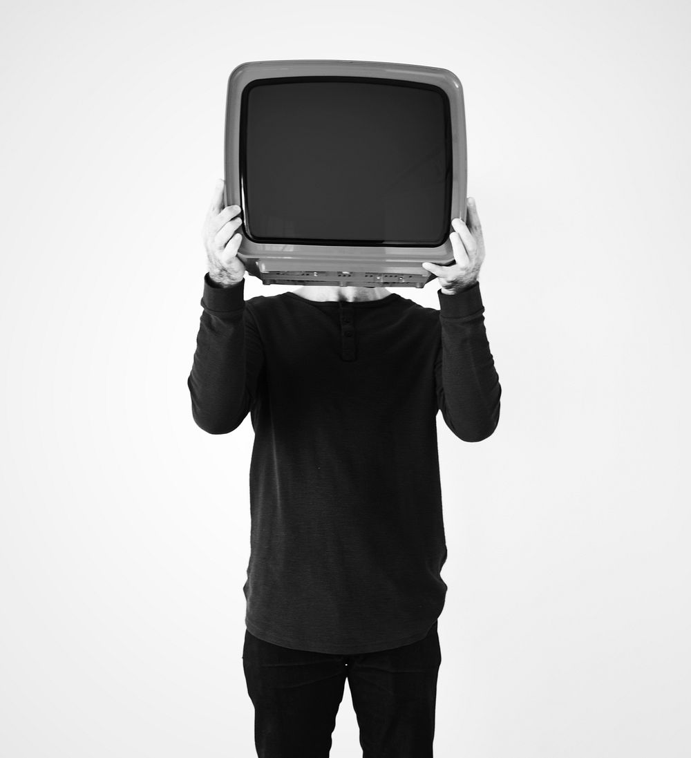 Man standing and holding a TV