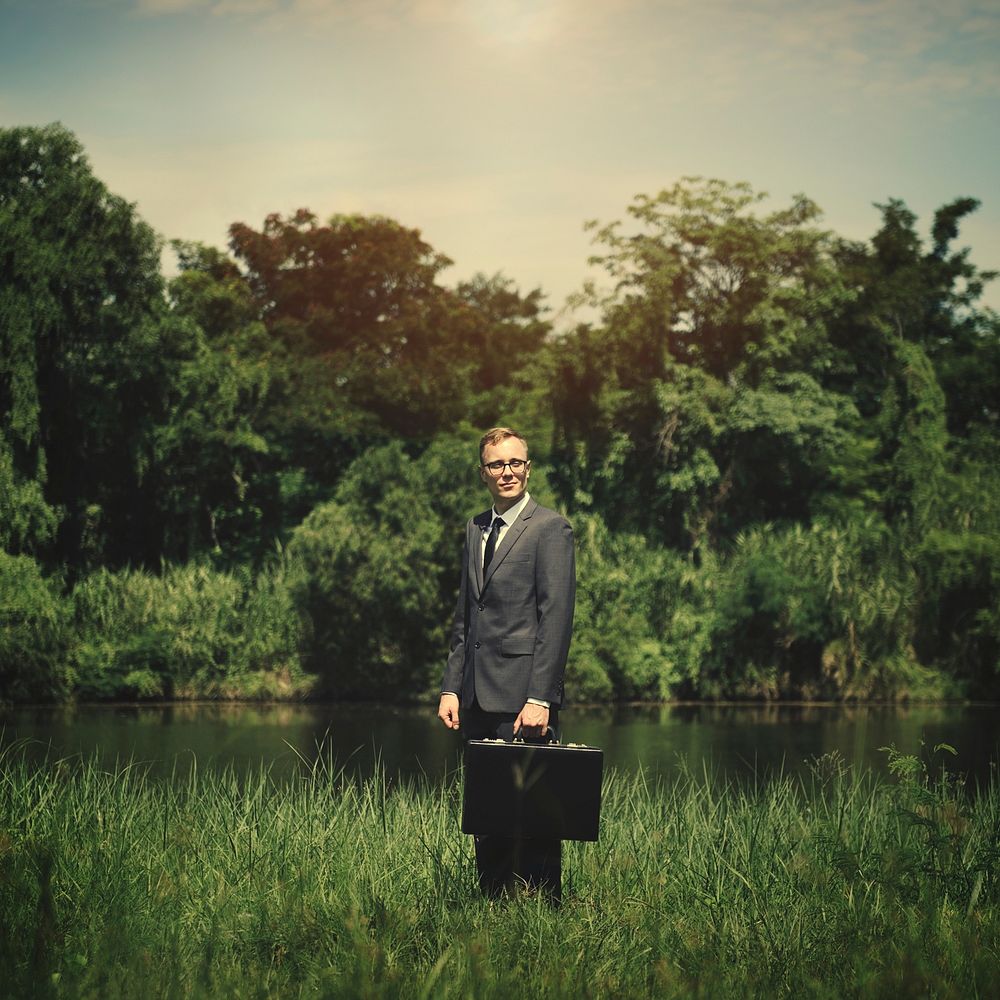 Businessman standing in a field