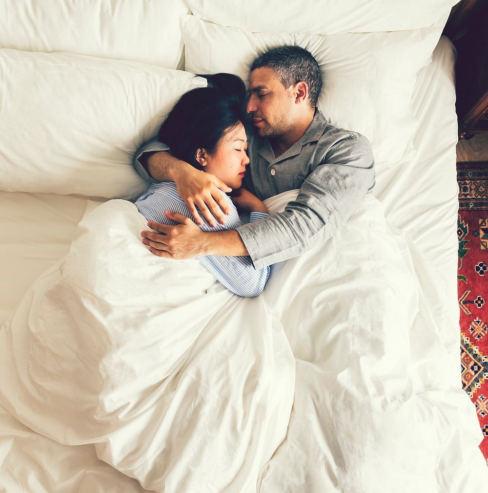 Couple sleeping together in a bed