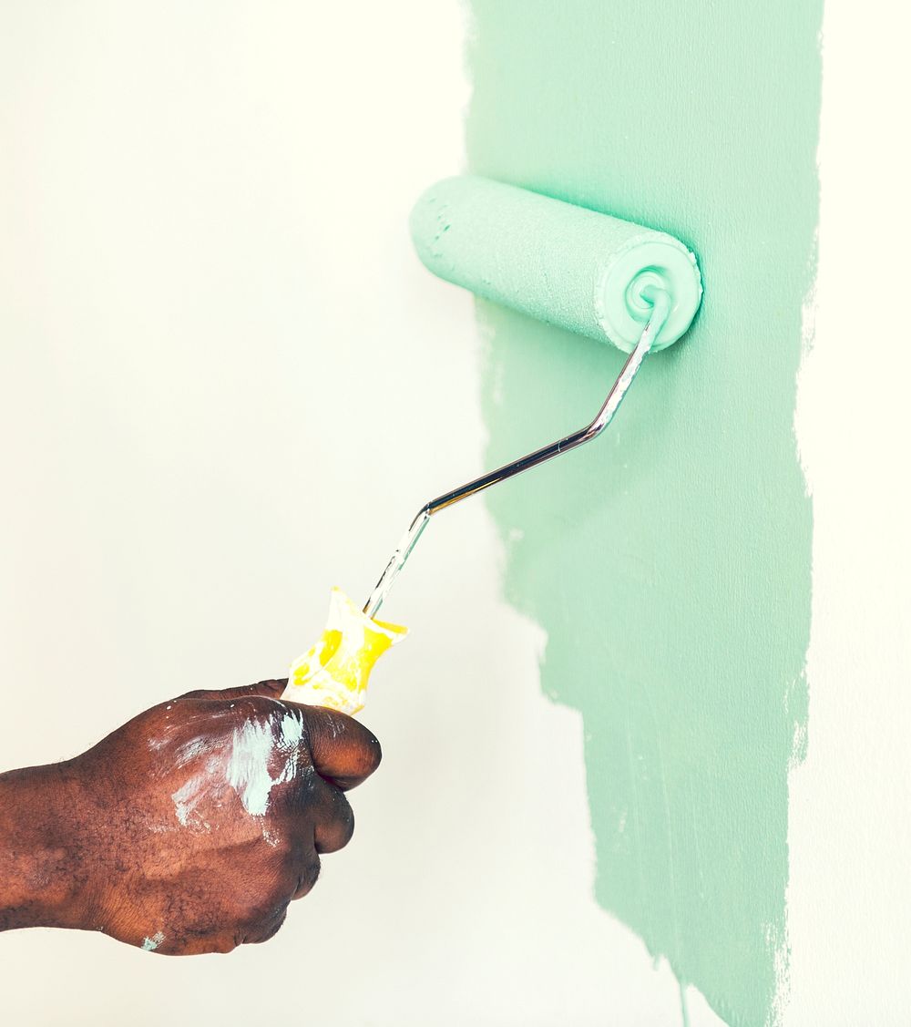 Man painting the wall green
