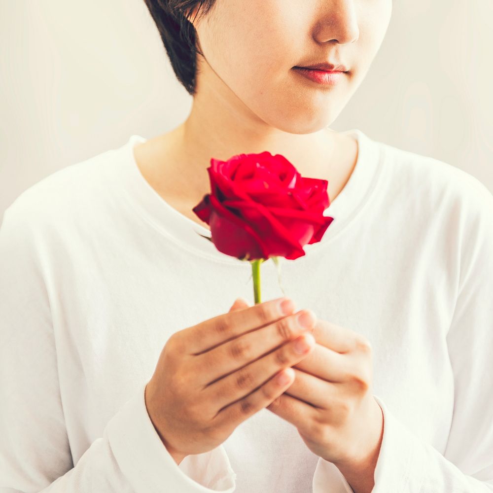 Asian girl holding red rose