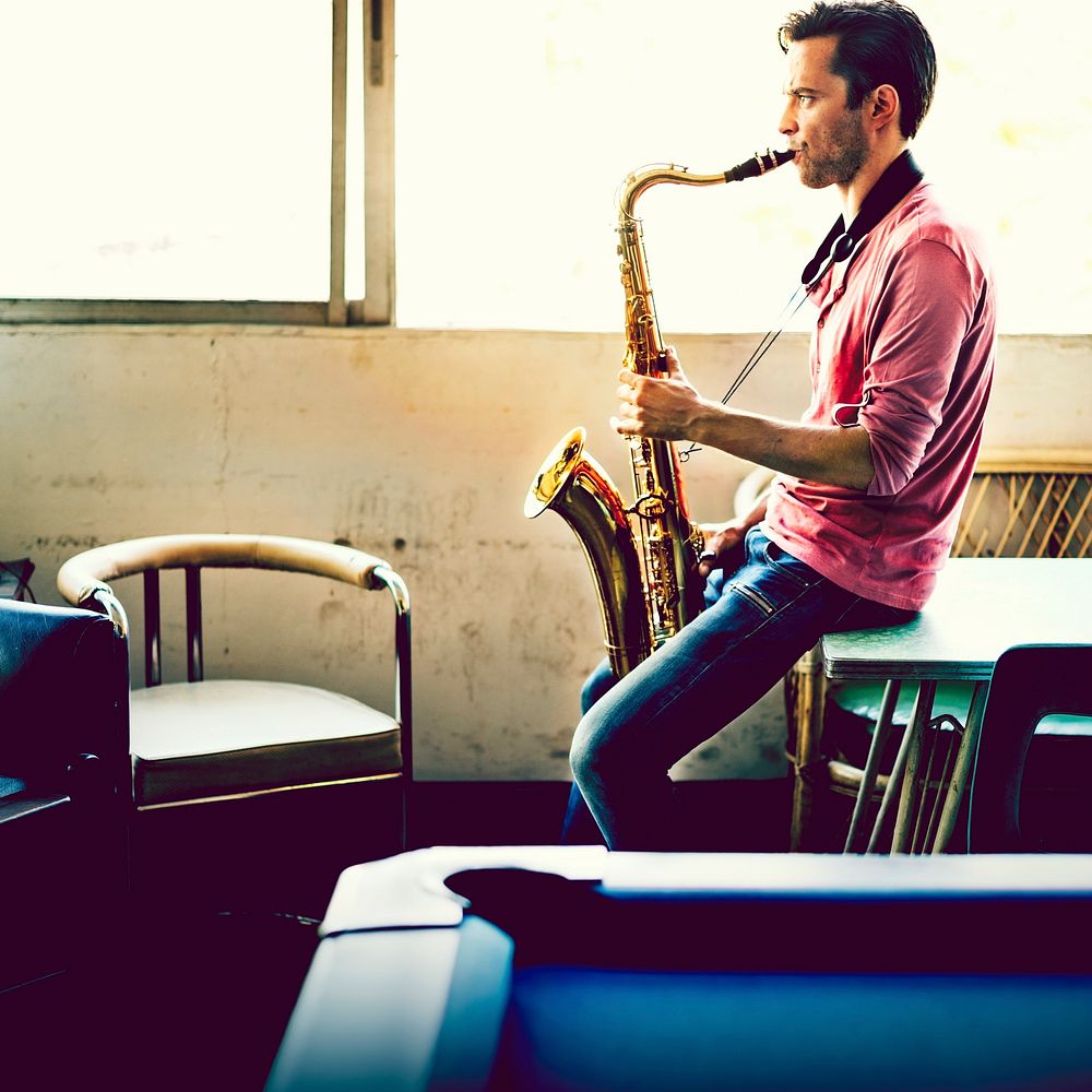 A musician guy playing saxophone alone