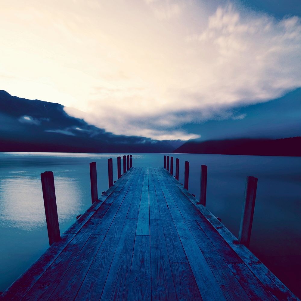 Boat jetty and a calm lake at sunrise, New Zealand