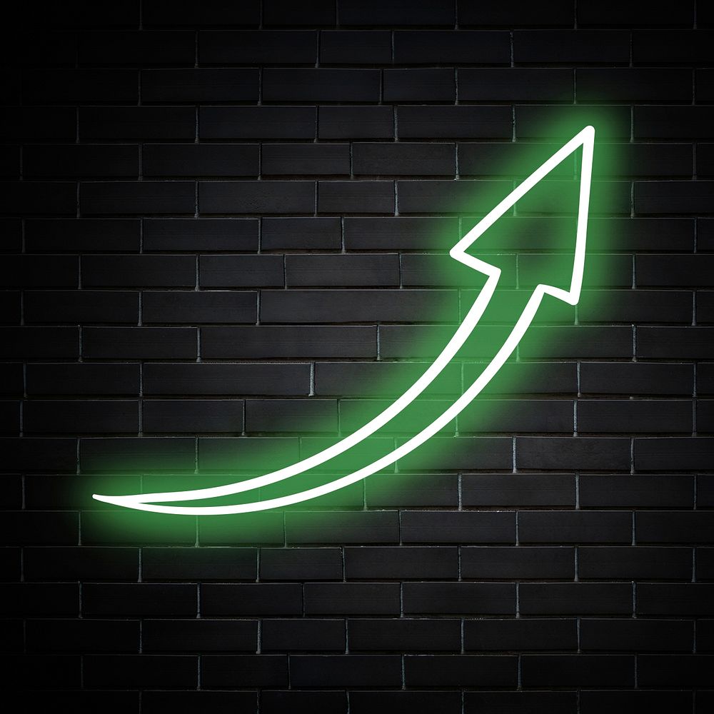 Neon green curved arrow sign on brick wall
