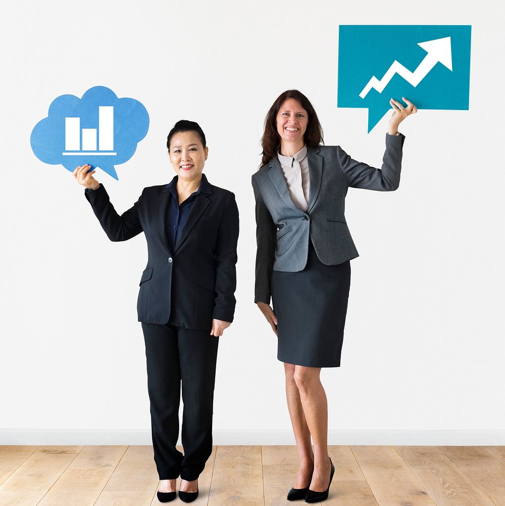 Businesswomen holding speech bubbles with growth icons