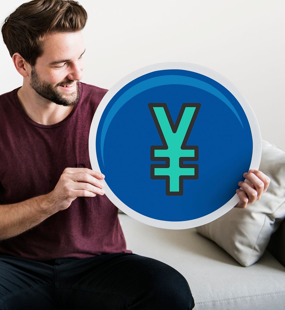 Young man holding a yen icon