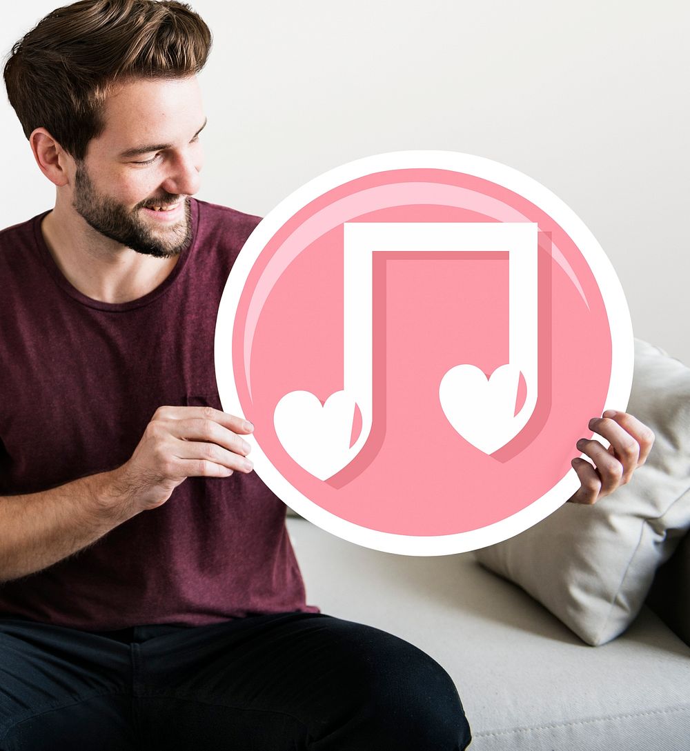 Cheerful man holding music note icon