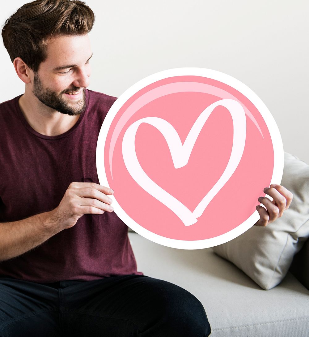 Cheerful man holding heart icon